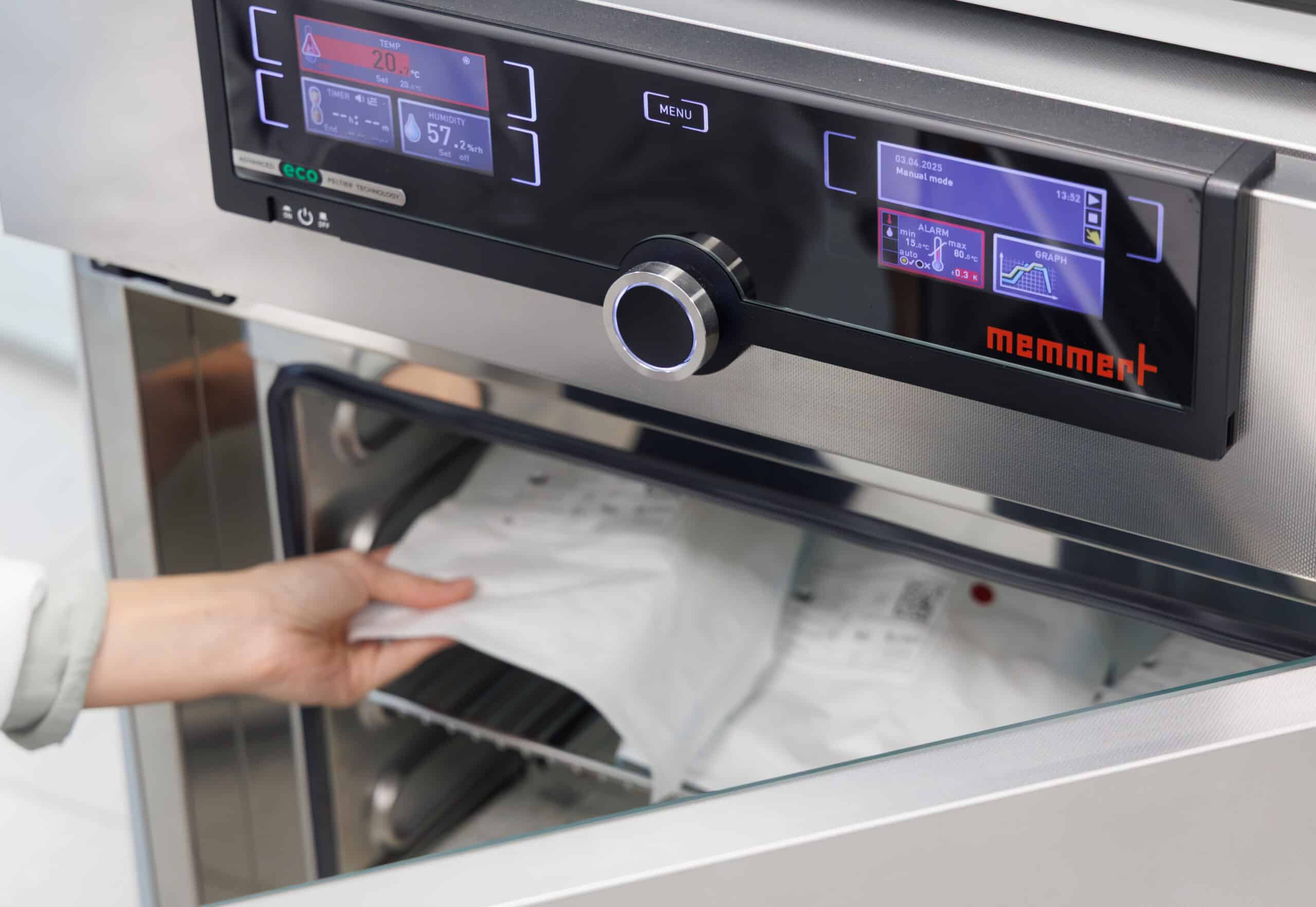 medical device being placed inside an accelerated aging oven by a medical device engineer