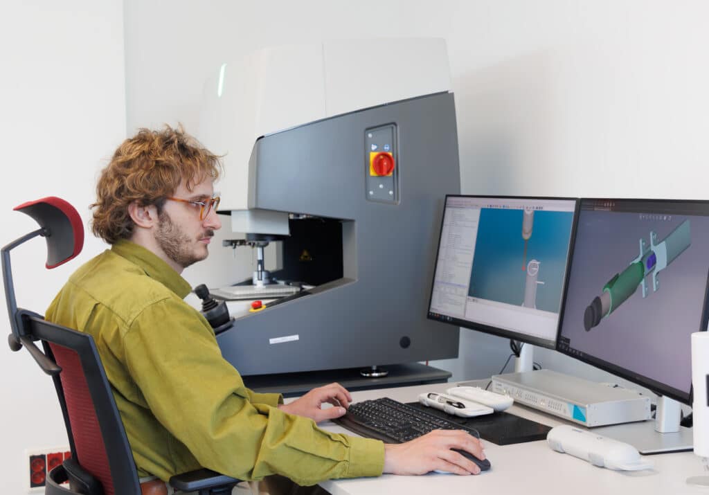 medical device DfM engineer conducting verification testing using a CNC machine